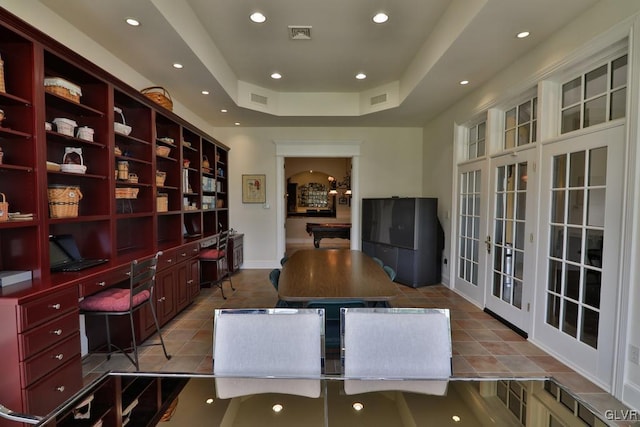 tiled home office with a raised ceiling, built in desk, billiards, and french doors