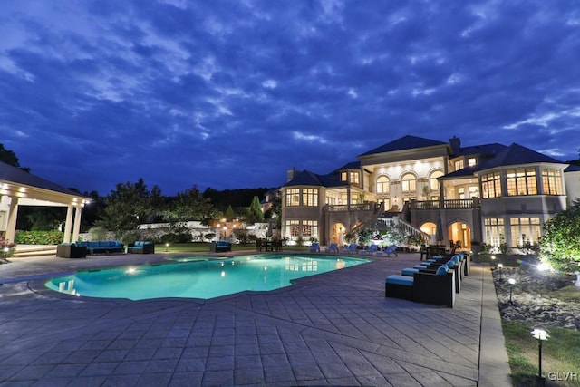 view of swimming pool with outdoor lounge area and a patio