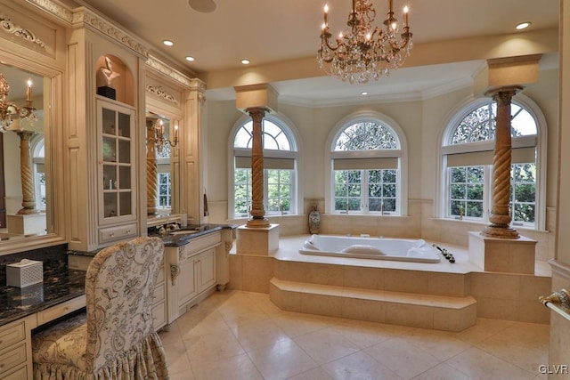 bathroom featuring tiled tub, plenty of natural light, vanity, and ornamental molding