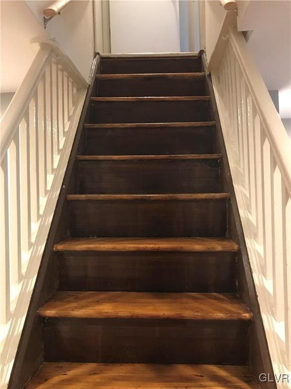 stairway featuring wood finished floors