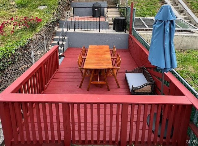 deck featuring a patio area and fence