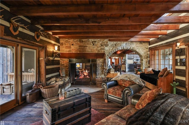 living room with beam ceiling, wood ceiling, and a fireplace