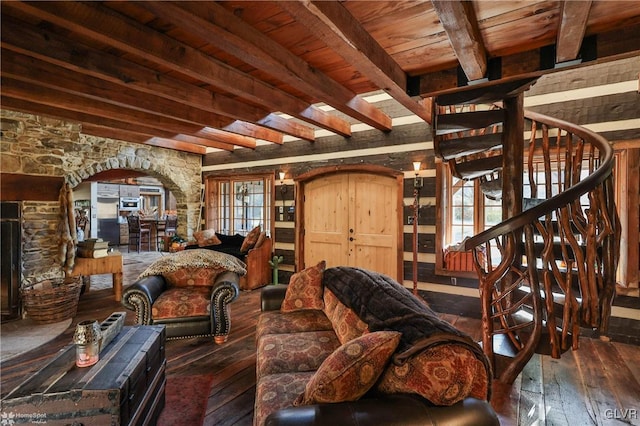 living room featuring beam ceiling, wooden ceiling, dark wood-type flooring, and a fireplace