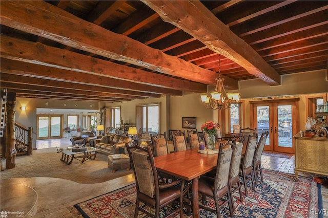 dining area featuring french doors, beamed ceiling, a wealth of natural light, and an inviting chandelier