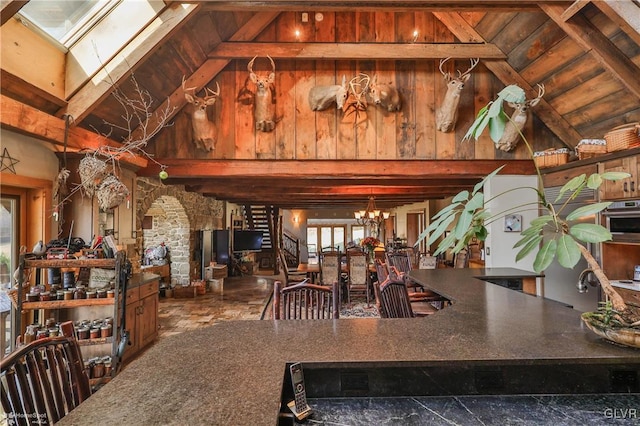 dining space with lofted ceiling with skylight and a healthy amount of sunlight