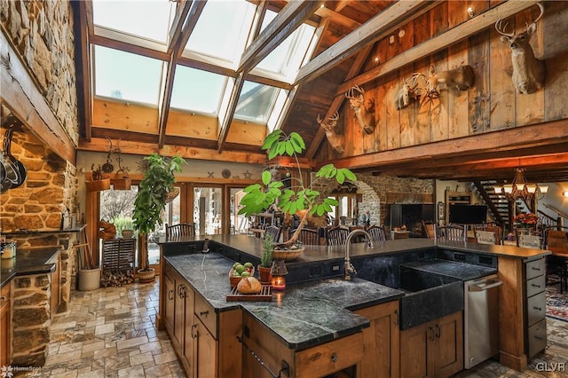 bar featuring high vaulted ceiling, dishwasher, beamed ceiling, a skylight, and sink