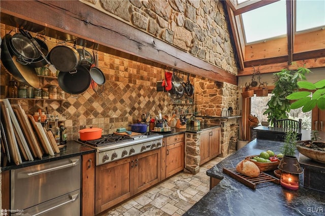 kitchen with decorative backsplash, a skylight, and stainless steel gas stovetop