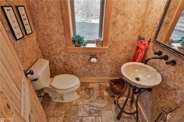 bathroom featuring toilet and a wealth of natural light