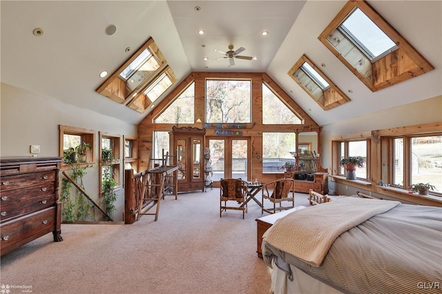 bedroom featuring light colored carpet, high vaulted ceiling, and a skylight