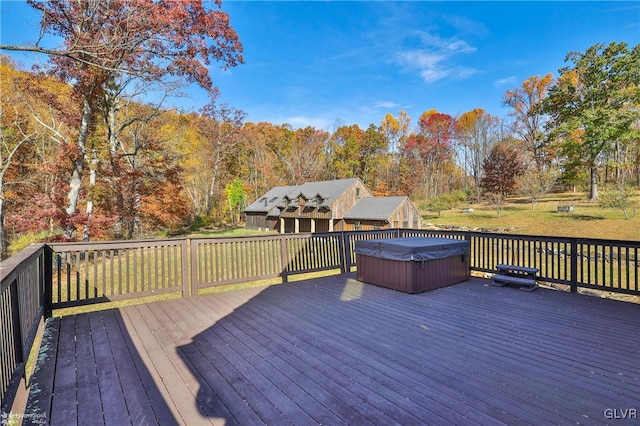 wooden deck with a hot tub and a lawn