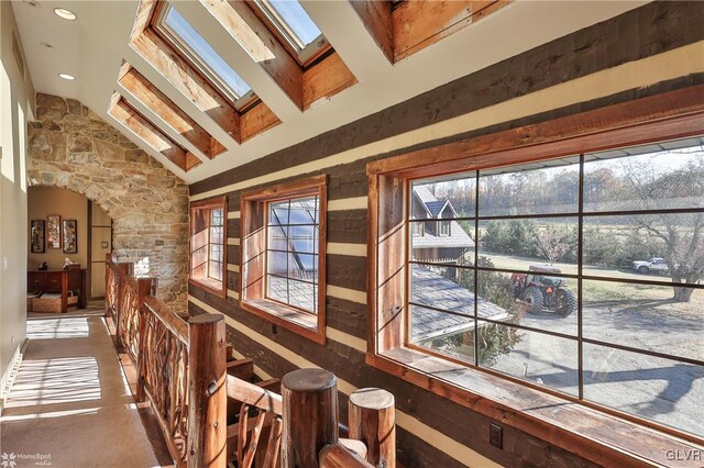 interior space featuring lofted ceiling with skylight