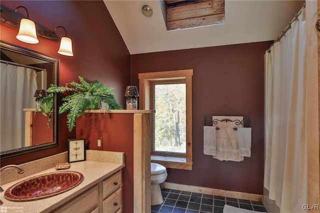 bathroom featuring toilet, vanity, tile patterned floors, and vaulted ceiling