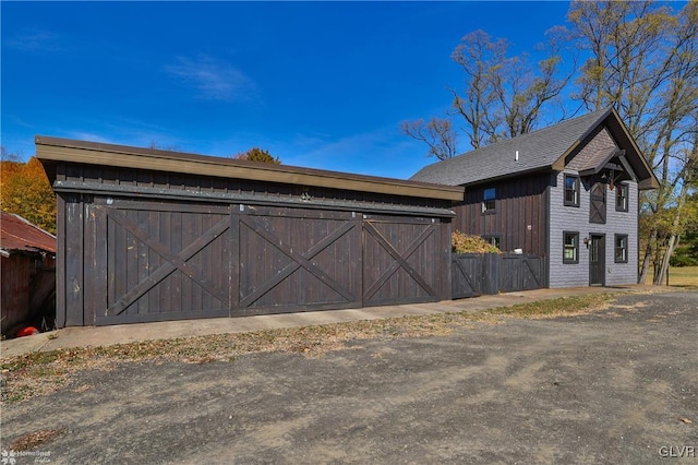 view of home's exterior with an outdoor structure and a garage