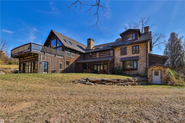 rear view of house featuring a yard