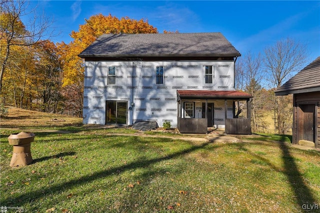 rear view of house with a yard