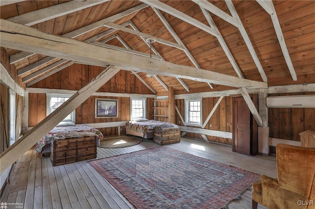 unfurnished bedroom featuring wood walls, hardwood / wood-style floors, lofted ceiling with beams, and wooden ceiling