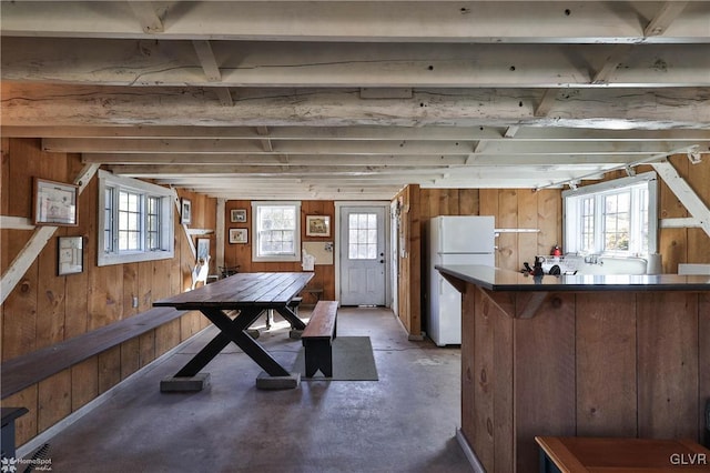 interior space featuring wood walls and white refrigerator