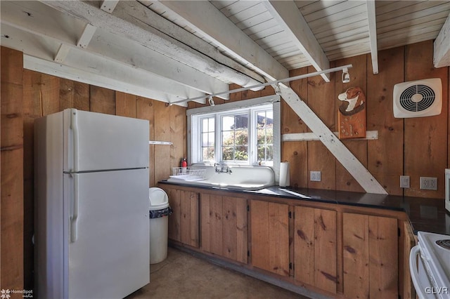 kitchen with white appliances and wood walls