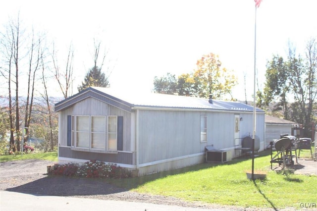 view of home's exterior with a yard and central AC unit