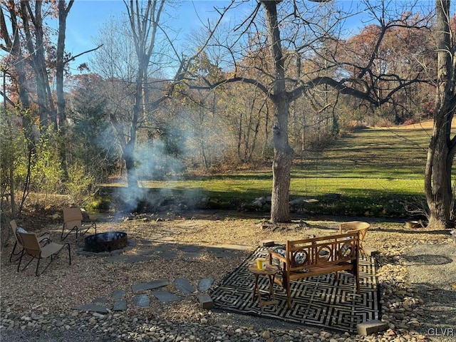 surrounding community featuring an outdoor fire pit