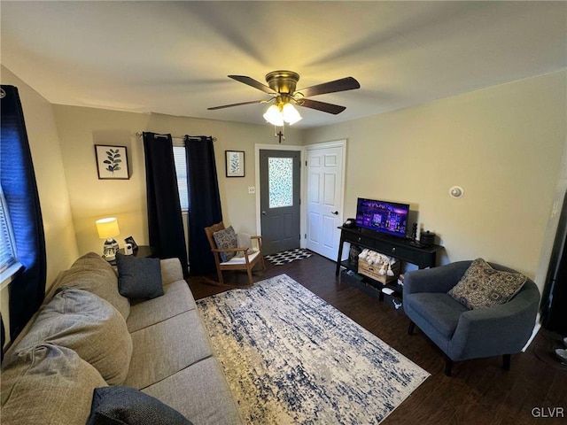 living room featuring dark hardwood / wood-style flooring and ceiling fan