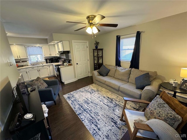 living room with sink, dark hardwood / wood-style floors, and ceiling fan