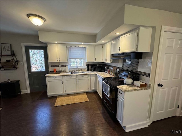 kitchen featuring backsplash, sink, black electric range, white cabinets, and dark hardwood / wood-style flooring