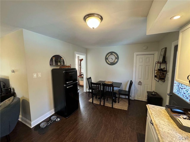 dining space featuring dark wood-type flooring