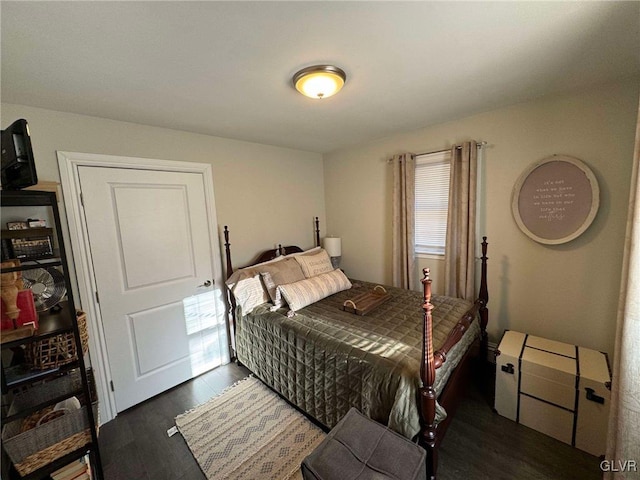 bedroom with dark hardwood / wood-style flooring