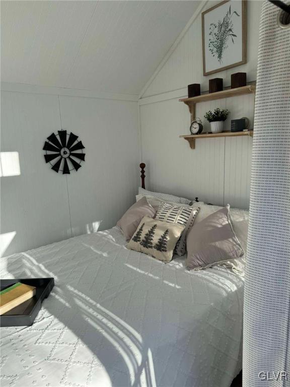 bedroom featuring lofted ceiling and ornamental molding