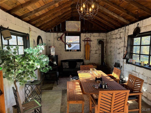 interior space with an inviting chandelier, a wood stove, lofted ceiling with beams, and wood ceiling