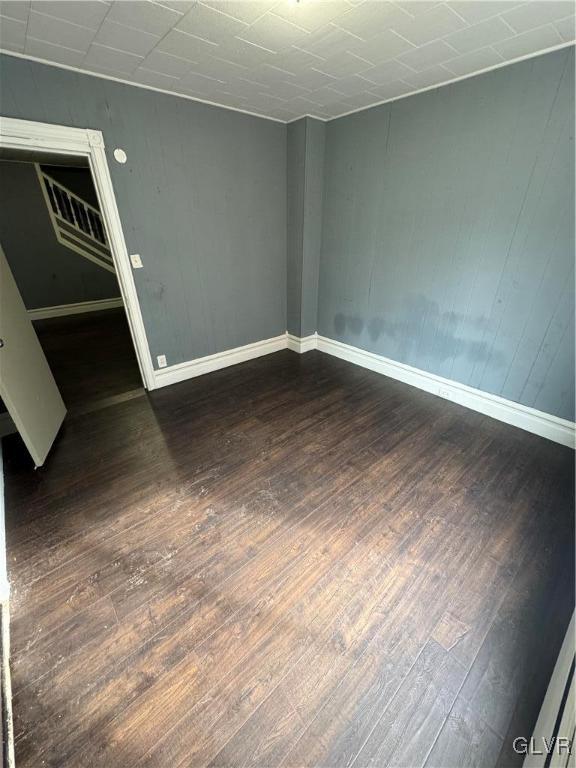 unfurnished room featuring dark hardwood / wood-style floors