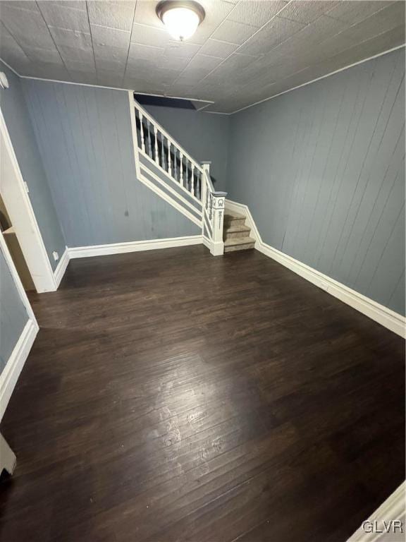 basement with dark hardwood / wood-style flooring