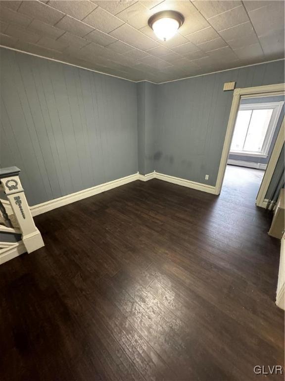 spare room with dark hardwood / wood-style flooring