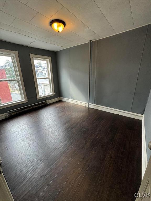 empty room featuring dark hardwood / wood-style floors