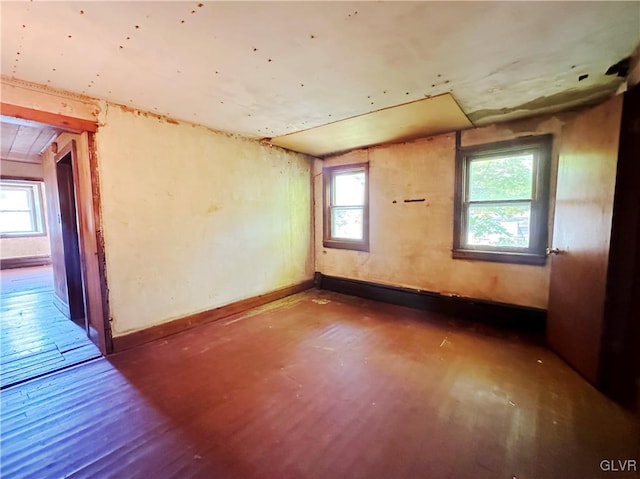 empty room featuring hardwood / wood-style floors and a healthy amount of sunlight