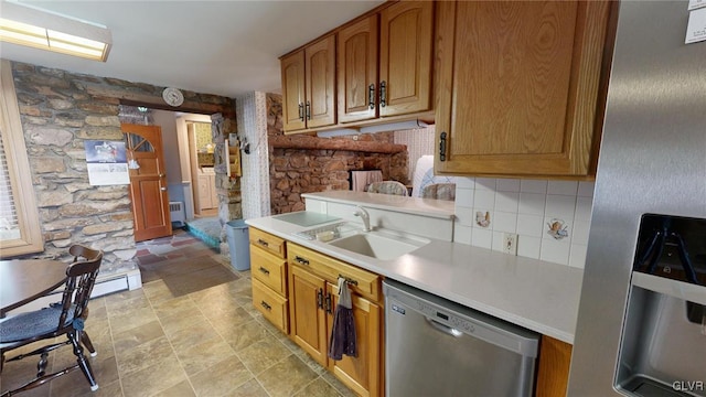 kitchen featuring stainless steel appliances, sink, and backsplash