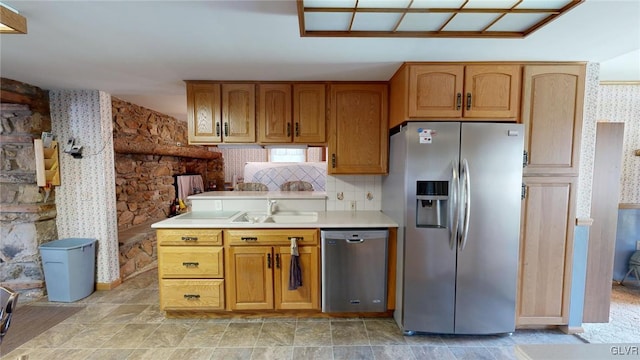 kitchen featuring sink, appliances with stainless steel finishes, and backsplash