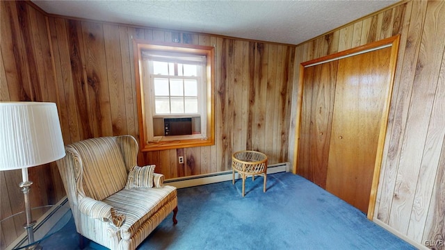 sitting room with dark carpet, cooling unit, and wood walls