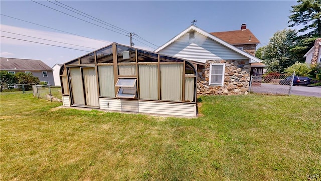 rear view of house featuring a lawn