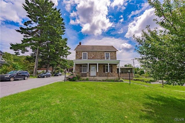 view of front of property with covered porch and a front lawn