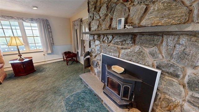 interior space with a textured ceiling, baseboard heating, and carpet