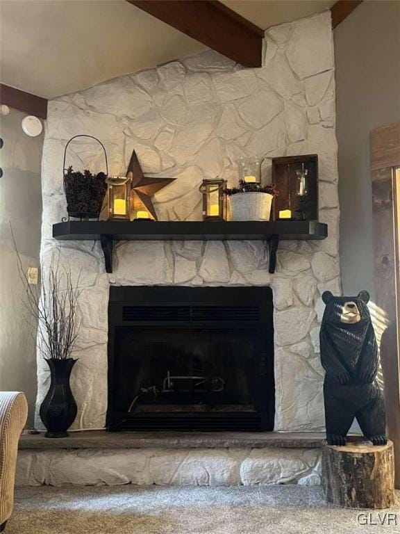 room details featuring a stone fireplace and beam ceiling