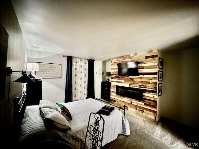 carpeted bedroom featuring a stone fireplace