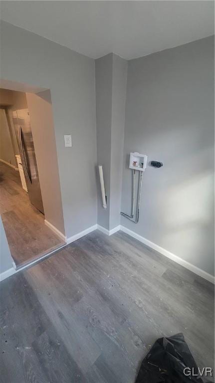 unfurnished room with dark wood-type flooring