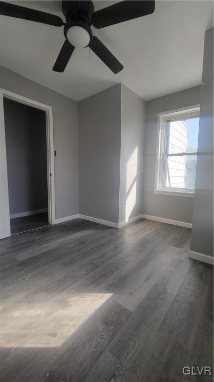 spare room with ceiling fan and dark hardwood / wood-style floors