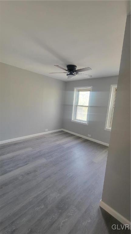 spare room featuring hardwood / wood-style flooring and ceiling fan