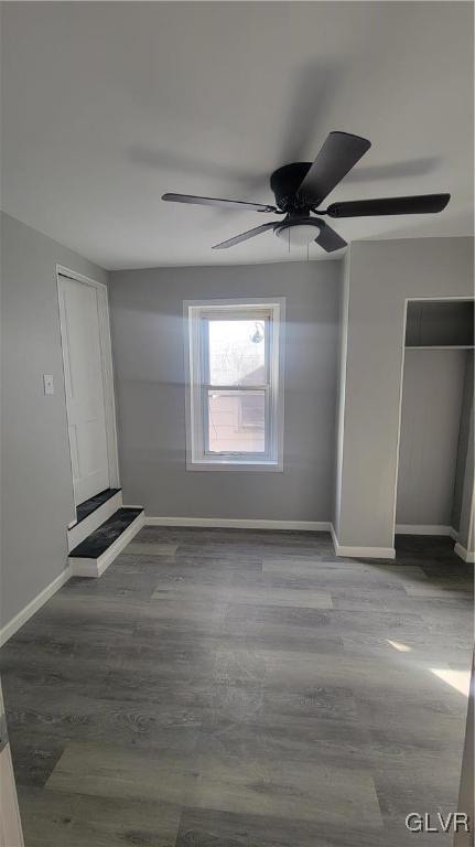 empty room with ceiling fan and wood-type flooring