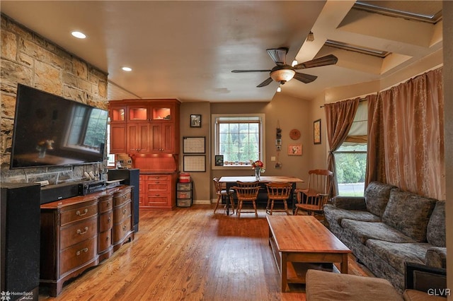 living room with lofted ceiling with beams, ceiling fan, and light hardwood / wood-style floors