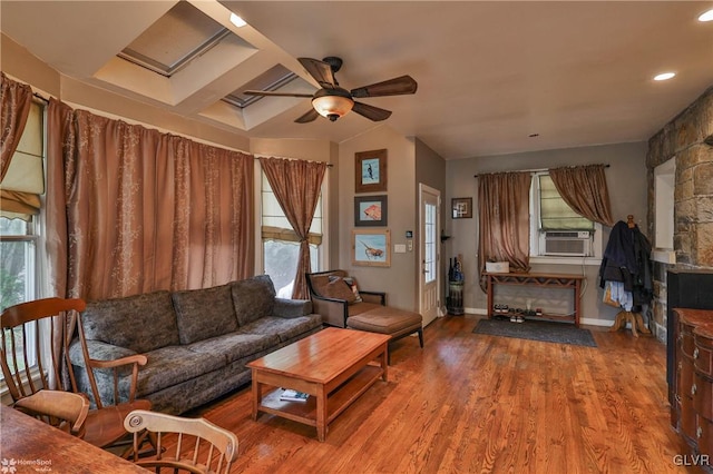 living room featuring hardwood / wood-style floors, ceiling fan, cooling unit, and coffered ceiling